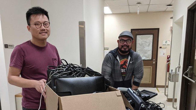 Peiwei and Frank organizing and moving donated items