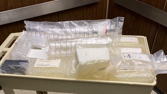 Cart full of plastic lab consumables