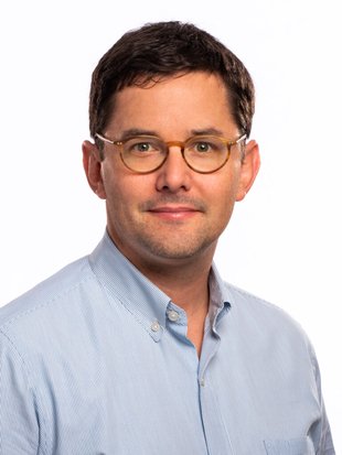 A photo of a man looking into the camera