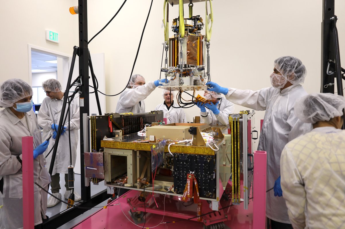 Engineers lower the DOLCE portion of the Space Solar Power Demonstrator onto the Vigoride spacecraft