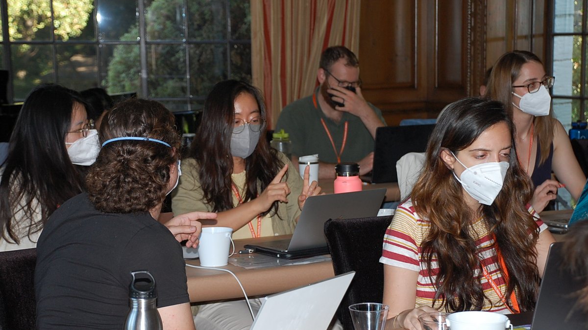 DataSAI Summer School Students sitting at desks working on laptops inside a classroom