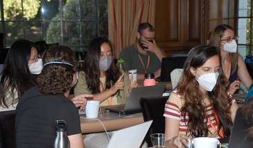 DataSAI Summer School Students sitting at desks working on laptops inside a classroom
