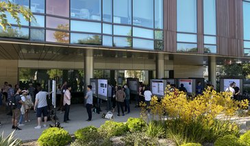 Poster session set up outside with a garden area in the foreground