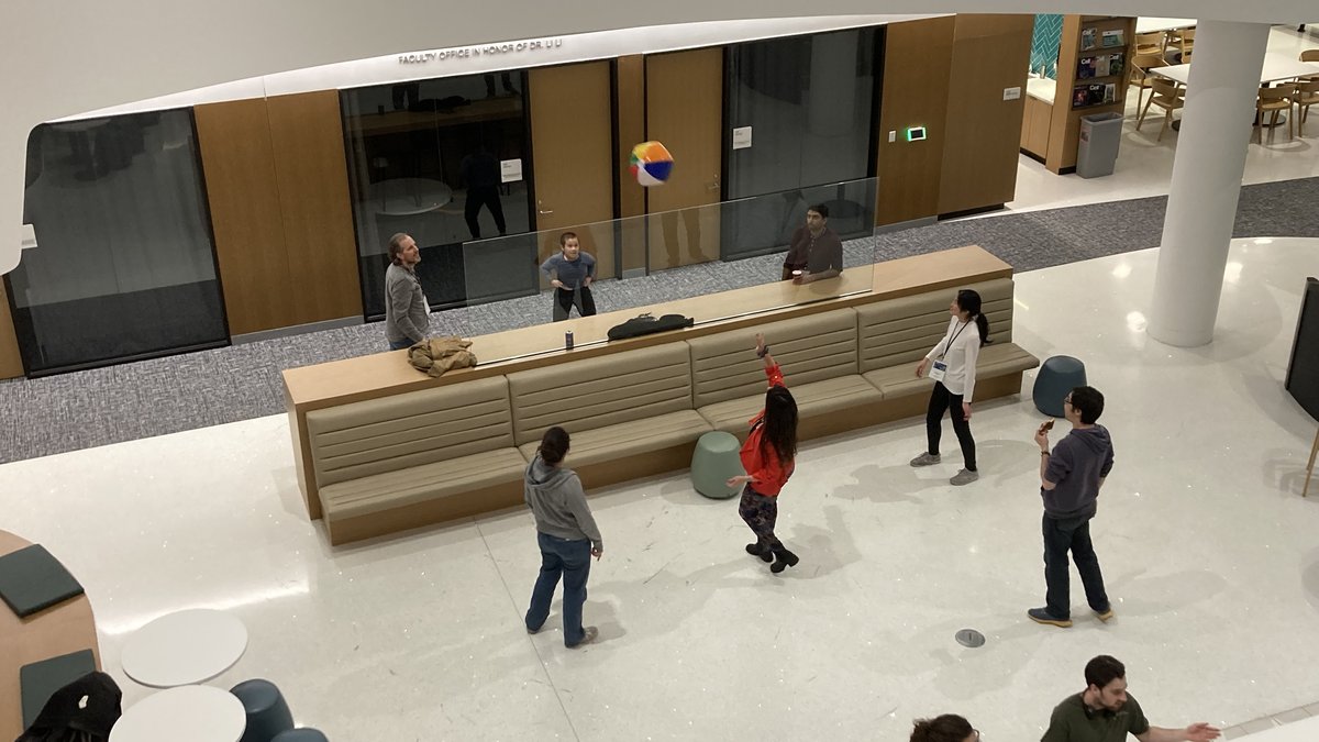 People playing volleyball with a beach ball inside
