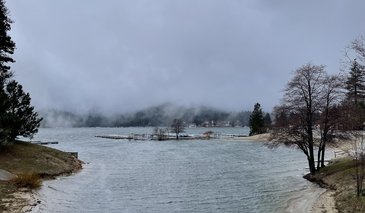 View of river joining lake with low clouds