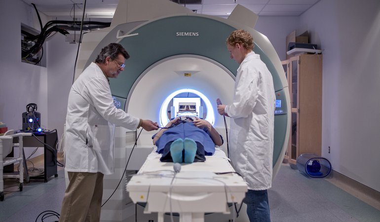 Ralph Lee, Manager of MRI Education and Technologies, Caltech Brain Imaging Center (left) and colleague preparing a subject for scanning.