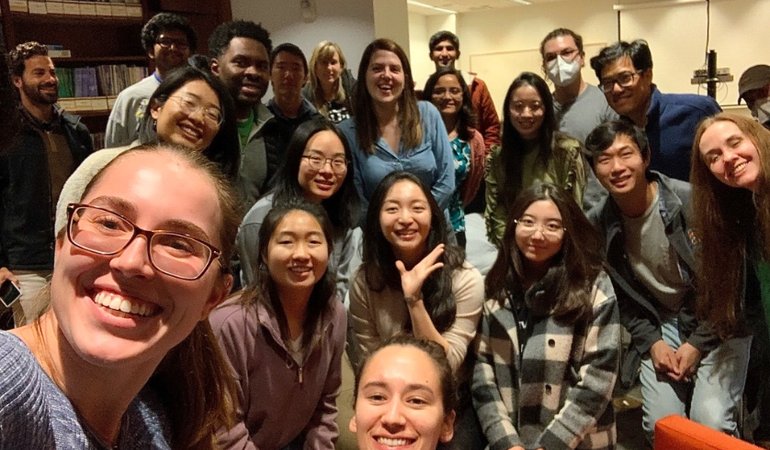 A photo of many smiling faces at the fireside chat with Georgia Gkioxari