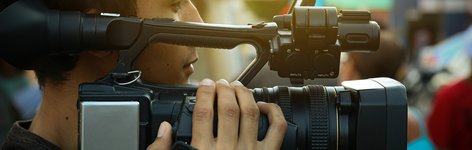 A photo of a man holding a video camera