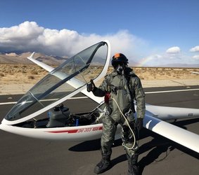 Keith Schwab standing next to a glider