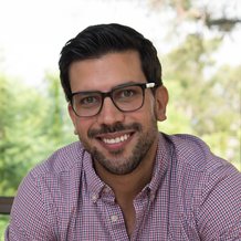 headshot of man with green shirt and brown hair