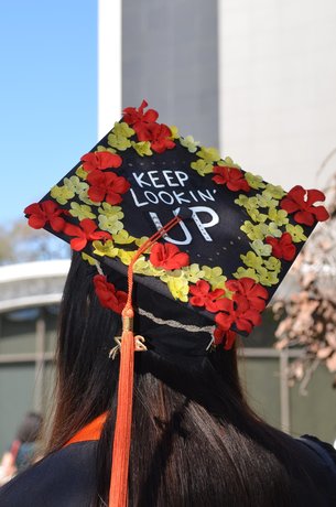 Back view of graduating student in hat saying Keep Looking Up