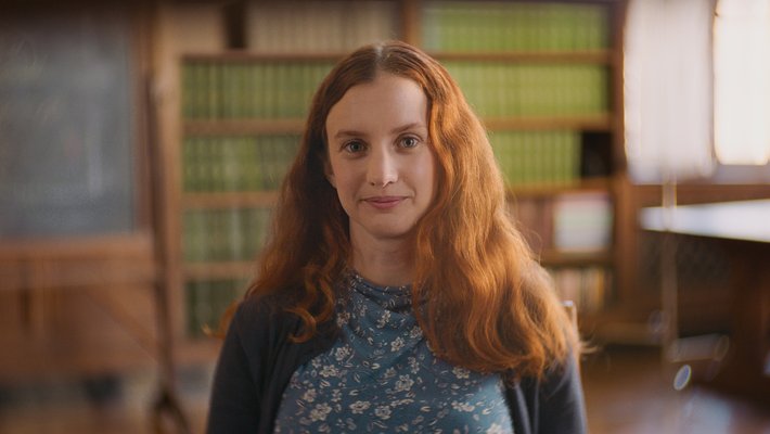 A person smiles for a photo