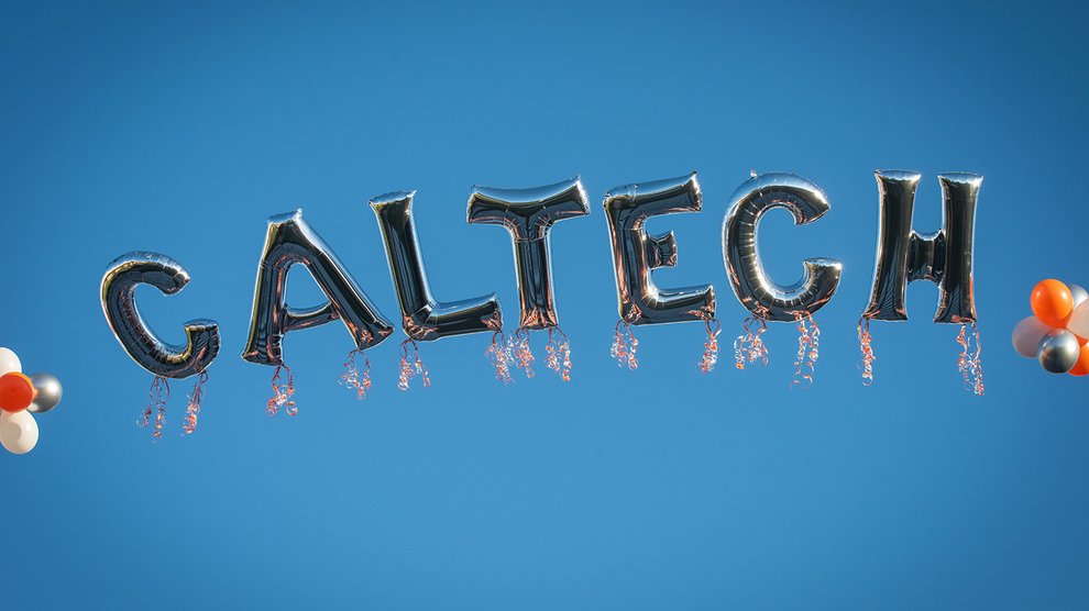 Balloons over commencement spell out "Caltech."