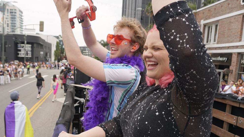 Catherine Romero (right) and grad student Alex Pavelic party on the Caltech float.