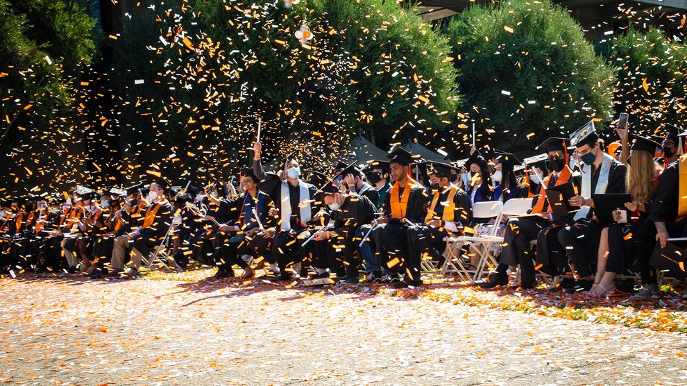 Confetti in the air as graduates celebrate.