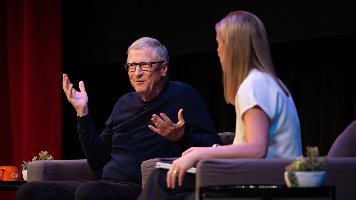 Bill Gates sits on stage in conversation with Amy Harder