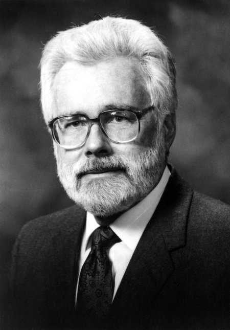 Profile of Arden Albee, wearing a jacket and tie, with white hair and beard.