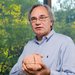 Richard Andersen holding a model of a brain.