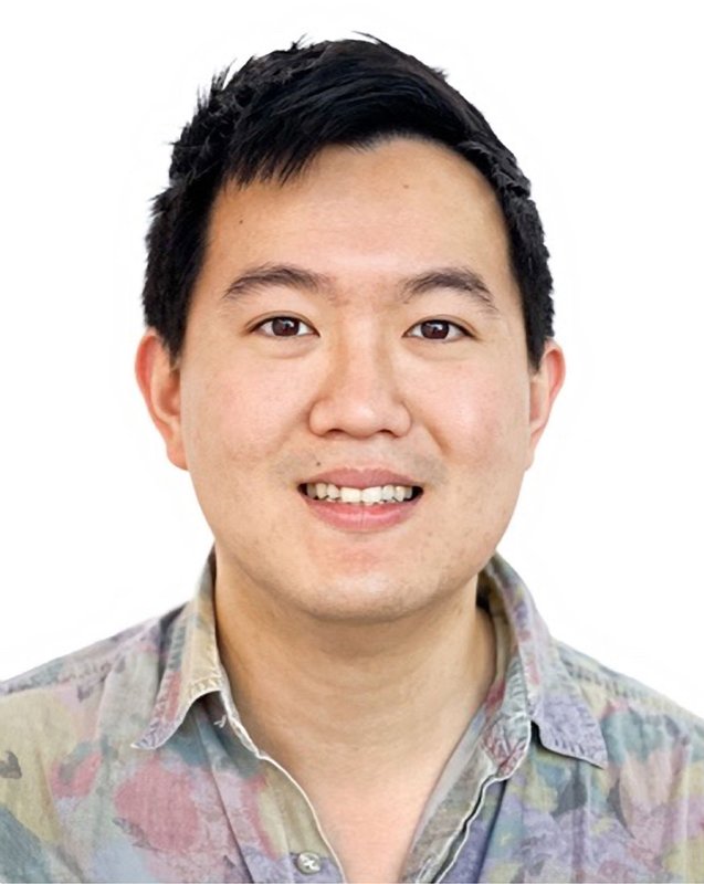 A man smiles for a photo