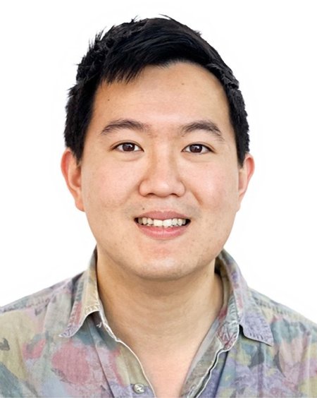 A man smiles for a photo