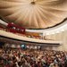 The audience assembles in brightly lit Beckman Auditorium