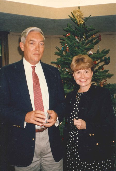 David Grether and Susan Grether stand in front of a Christmas tree.