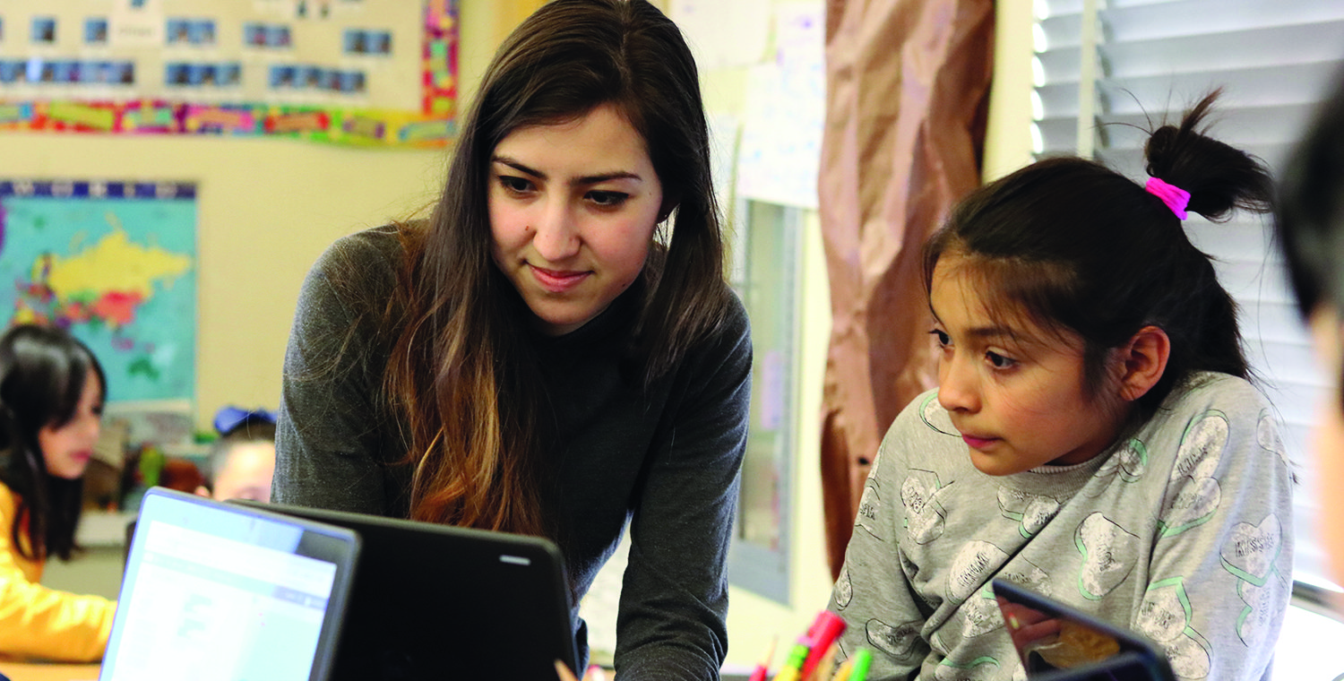 A Caltech computer science student helps a Pasadena third grader learn to code.