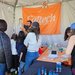 Alex Johnson explains scientific equipment to guests at Caltech's booth.