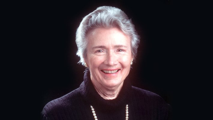 A smiling woman looking into the camera