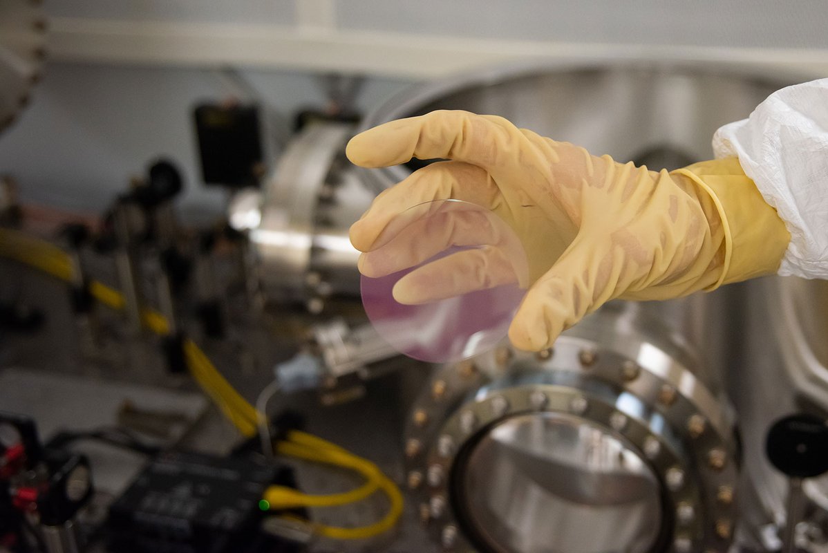 A pinkish coating on a test mirror disk.