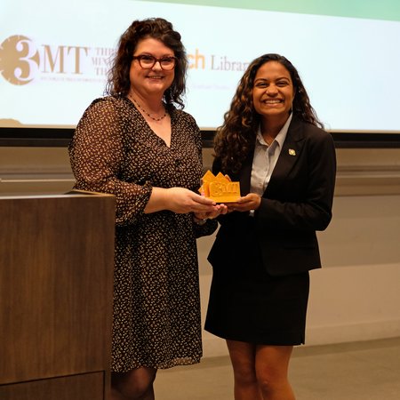 University Librarian Kara Whatley hands award to Niyati Desai