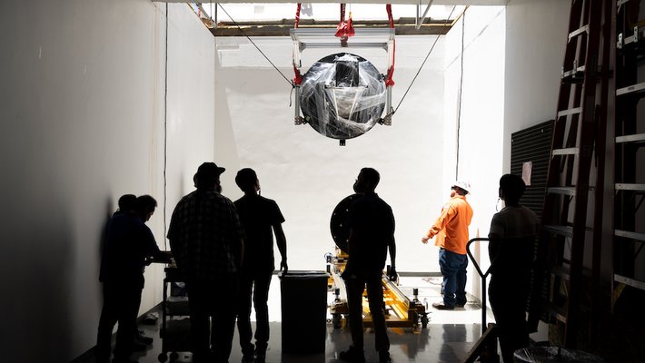 SPHEREx hardware being lowered into a basement lab.