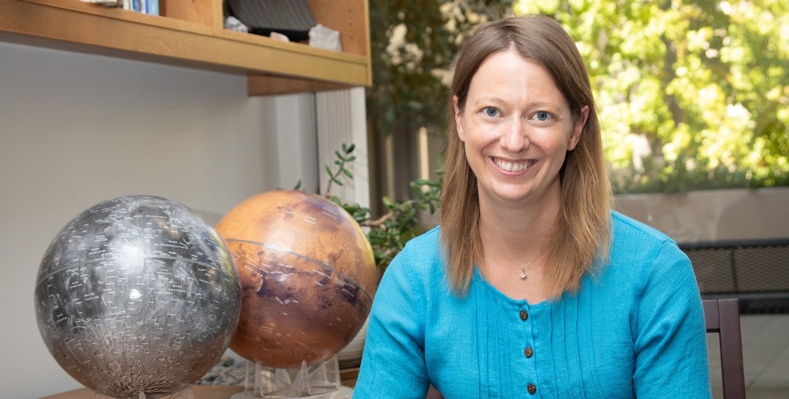 Image of Bethany Ehlmann in office wearing blue shirt.