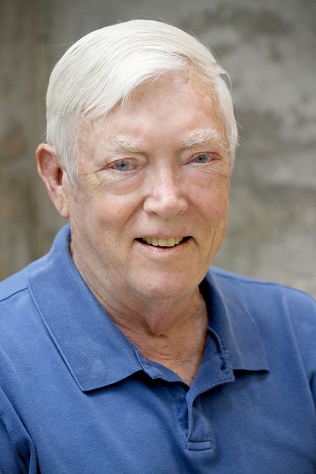 A portrait of David Grether. He smiles at the camera and wears a blue polo shirt.