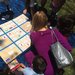 Families collaborated on a challenging variation of the game SET in which players create a quilt of mathematical patterns.