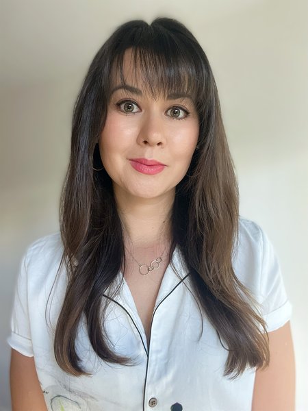 A person with dark hair in a blue shirt