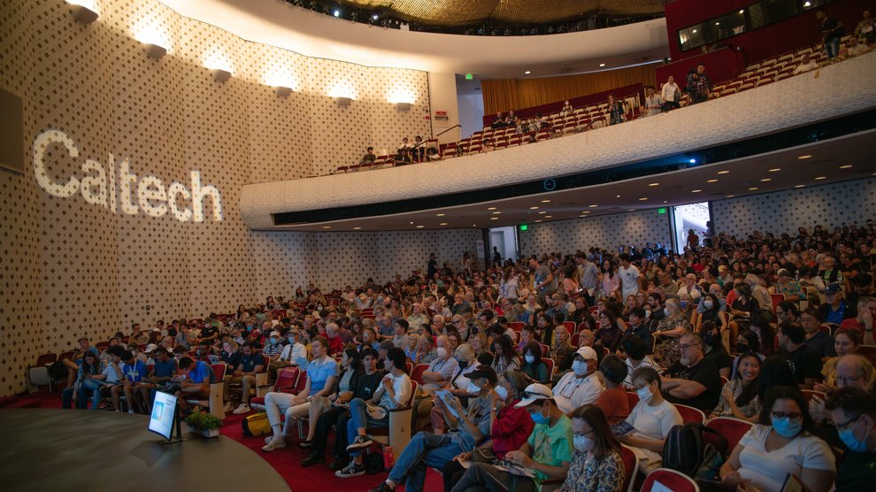 A crowd sits in Beckman Auditorium, ready for the show to begin.