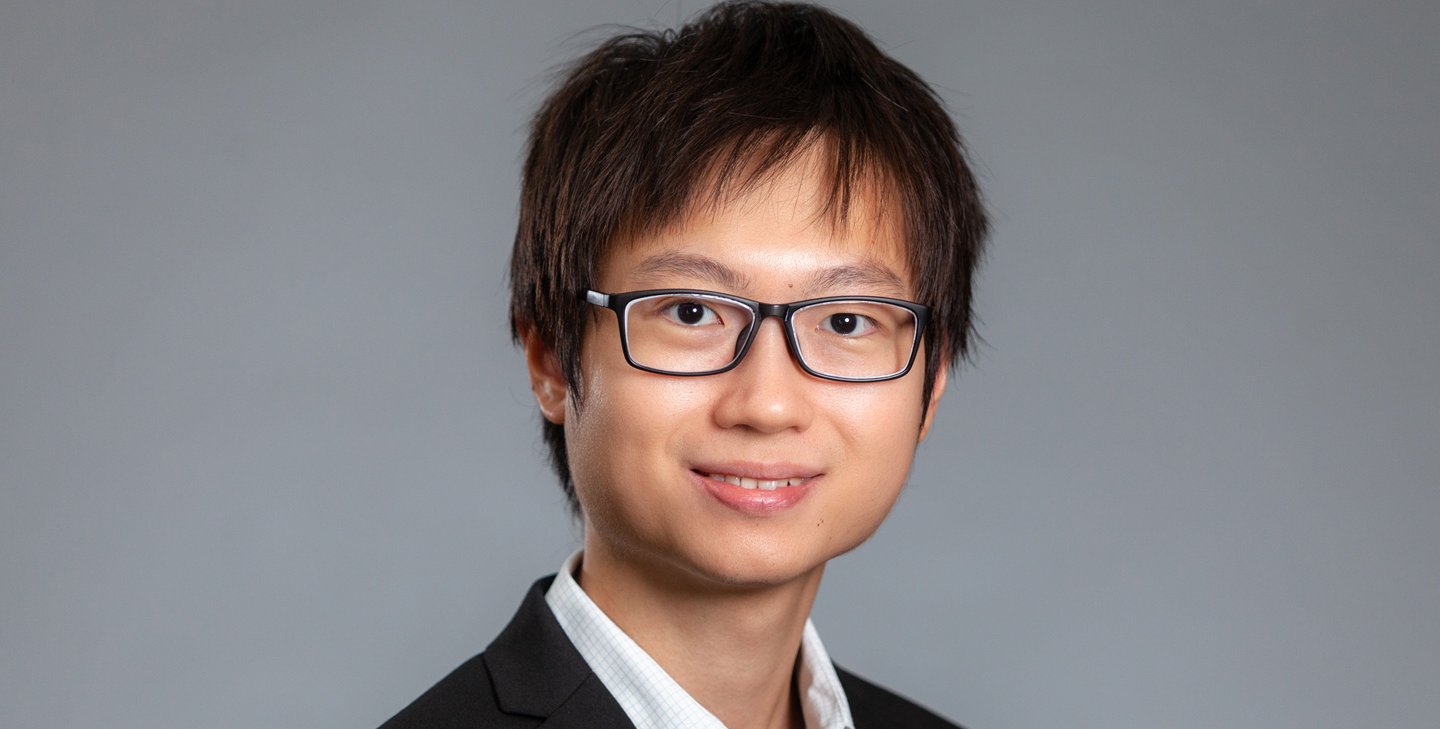 Headshot of Jin Ming Koh with dark glasses and dark sports jacket