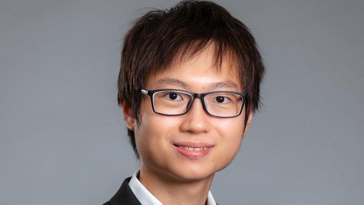 Headshot of Jin Ming Koh with dark glasses and dark sports jacket