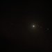 Artwork of the HR 8799 system showing a white star and four red planets.