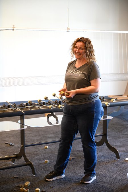 Amber Strunk demonstrates one of the new exhibits at the LIGO Exploration Center.