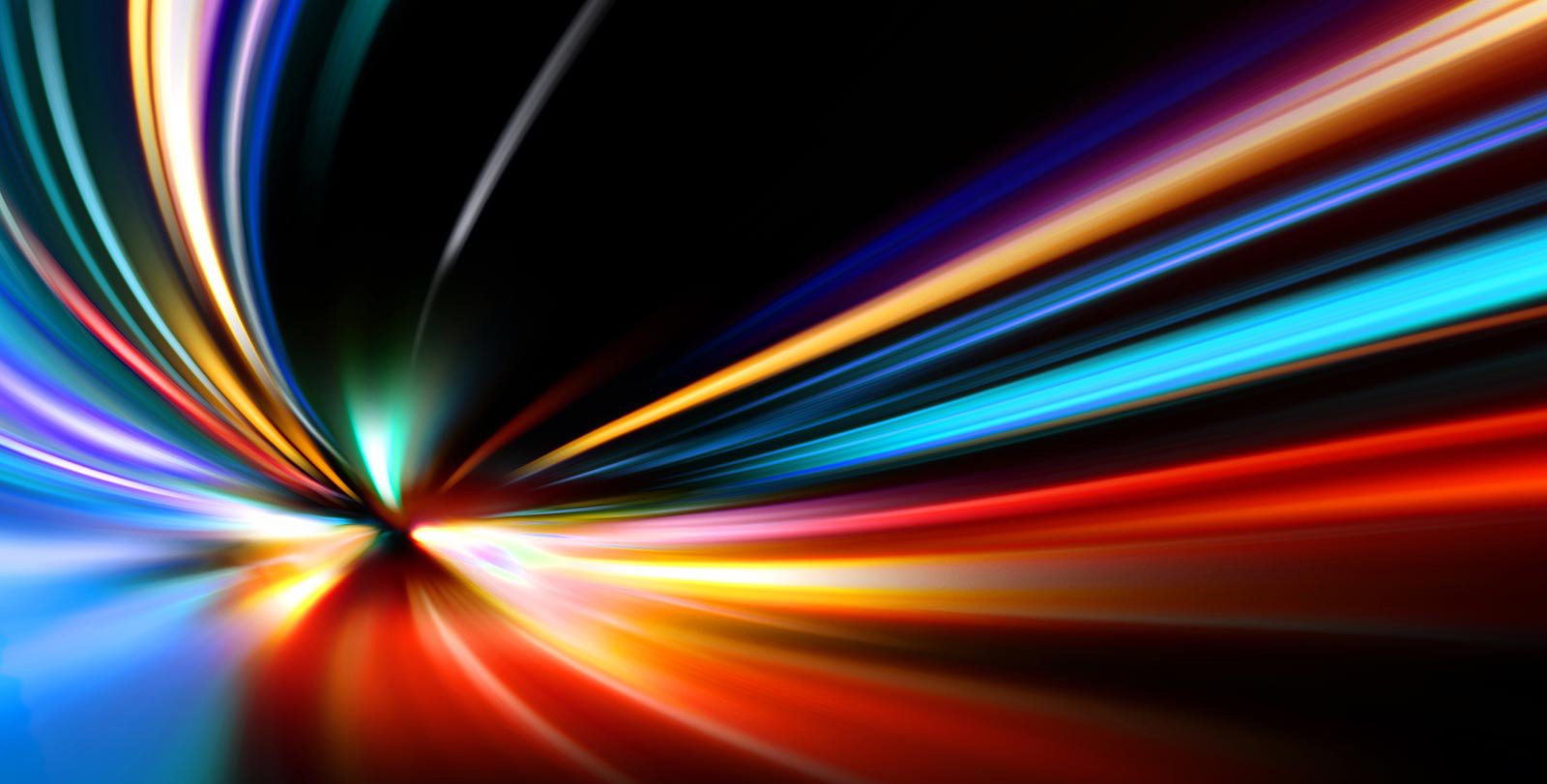 Streaky colored lights appear to zoom toward the viewer against a black background