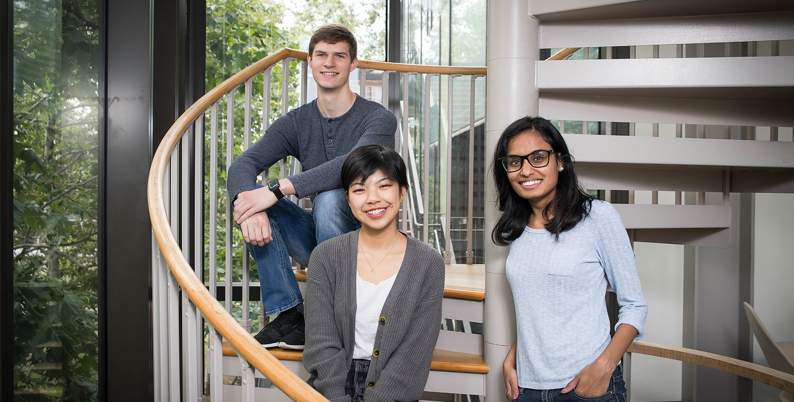 Students Andrew Hess, Myra Cheng, and Nivetha Karthikeyan, founders of the TechReach club, sit in the Annenberg Center for Information Science and Technology.