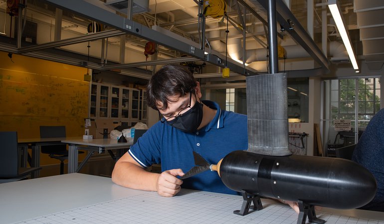 Caltech junior Tyler Nguyen working on a fish-inspired robot