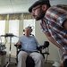 A man and a woman in a wheelchair examine a screen