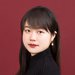 Portrait of Seo-young Silvia Kim in a black turtleneck on a red background