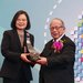 Sunney Chan and the president of Taiwan pose together with an award.