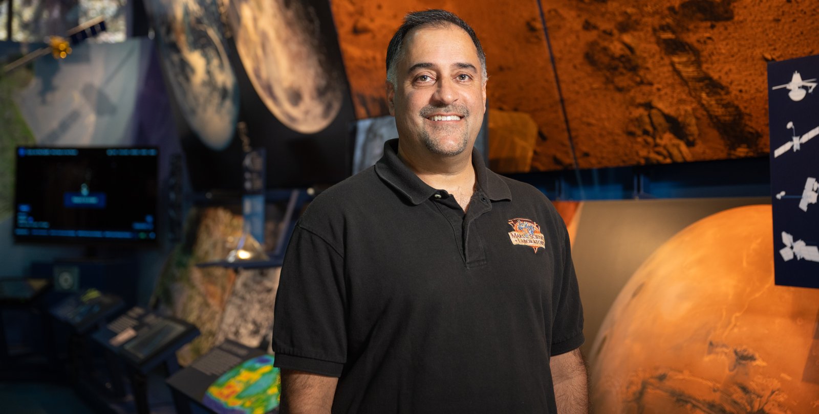 Image of Ashwin Vasavada standing in front of Mars display