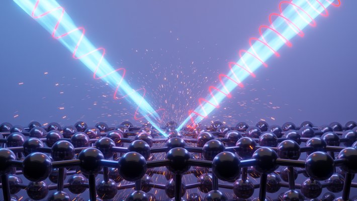 A computer generated image of a bean of light bouncing off a sheet of atoms (represented by spheres). The light has a spiral feature that changes after it bounces.