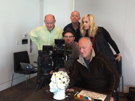 People gathered around cameras to look at video